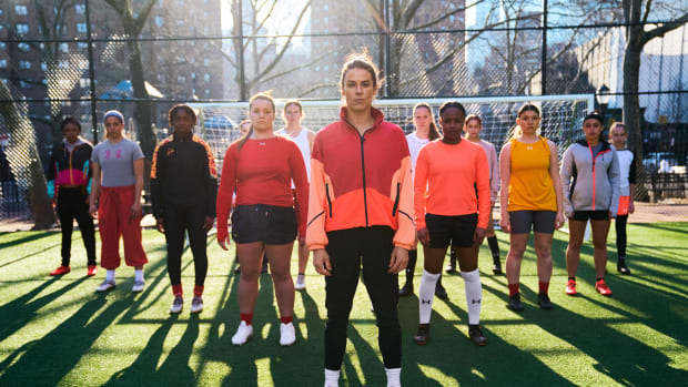 Kelley O'Hara and women model Under Armour soccer apparel.